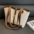 Canvas tote bag in beige and brown leather contrast with a golden metallic twist lock - Coffee
