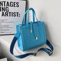 Azure blue structured square shoulder bag with golden hardware and wide fabric strap - Sky Blue