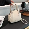 Chic cream white shell handbag with dual handles and adjustable shoulder strap - White