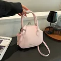 Minimalist light pink shell bag with vintage metal clasp and adjustable strap - Pink