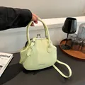 Pale green minimalist kiss-lock shell handbag with detachable crossbody shoulder strap - Green