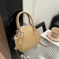 Chic beige doctor bag style shell purse with silver clasp and adjustable strap - Khaki