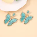 Pendientes de mariposa hechos a mano con marco dorado y bordado de hilo azul turquesa - Azul