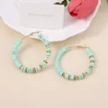 Detailed shot of mint green polymer clay beads and gold spacers on round hoop earrings - Emerald Green