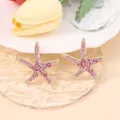 Macro detail of starfish earrings with pink zircon pavé on a golden base design - Starfish With Rose Red Rhinestones