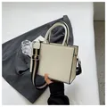 Chic off-white square handbag with diamond quilting and a striped wide strap - White