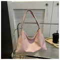 Pink minimalist shoulder tote bag made of smooth material shown on a display stand - Pink