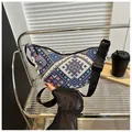 Detalle de bolso bandolera bohemio con patrón tejido geométrico colorido y correa negra - Azul