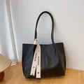 Classic black tote bag with leather texture and white fashion ribbon decoration - Black