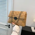 Quilted beige crossbody bag with metallic chain strap and minimalist buckle closure - Khaki