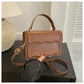 Caramel brown square crossbody bag with unique wavy edge flap and golden hardware - Dark Brown