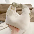 White faux fur handbag with cream pleated handle and golden engraved charm for winter - Off White