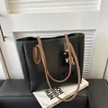 Minimalist black tote bag with brown straps and cute sheep pendant for daily commute - Black With Cartoon Charm