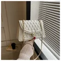 White quilted PU leather crossbody bag with gold chain strap and metal lock closure - White