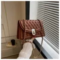 Brown quilted crossbody bag with gold chain strap and turn-lock closure detail - Dark Brown
