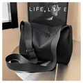 Minimalist black nylon crossbody tote bag with dual zippers and adjustable strap - Black