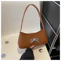Chic brown underarm shoulder bag featuring a glittering rhinestone bow decoration - Dark Brown