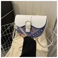 Ethnic patchwork saddle bag with white leather flap and rainbow woven fabric detail - White