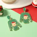 Detail of Christmas green ugly sweater earrings with Santa Claus beads and gold alloy finish - Green Sweater Style / Green