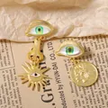 Vintage gold matte asymmetrical evil eye earrings with sun pendant and coin detail - Green Eye