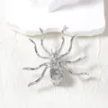 Macro shot of silver spider brooch with rhinestone details and realistic limb joints - Silver
