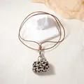 Detail of leopard print mini pouch pendant with bronze snap button and brown lanyard - Cow Print Bag Pendant