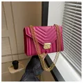 Deep pink chain crossbody bag with V-shaped quilting and gold metal lock detail - Rose Red