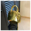 Glossy gold shell-shaped crossbody bag with quilted pattern and metallic finish - Gold