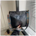 Large black PU leather shoulder bag with colorful woven strap for stylish women - Black