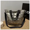 Detail view of silver quilted tote bag with metallic texture and detachable shoulder strap - Gold