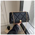 Minimalist black quilted crossbody bag with gold chain strap and metallic clasp - Black