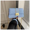 Light blue quilted crossbody bag with gold chain strap and elegant metallic buckle - Blue
