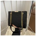 Fashionable black quilted shoulder bag with golden chain straps and geometric pattern - Black
