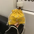 Yellow drawstring bucket bag with white floral embroidery and cotton cord handle - Yellow