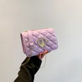 Quilted lavender crossbody bag with gold heart locket and chain strap detail - Purple