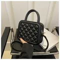 Black quilted crossbody bag with small studs and golden metal hardware details - Black