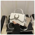 Minimalist white leather crossbody bag with silver moon buckle and top handle - White