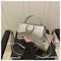 Chic silver crossbody bag with crescent moon buckle and litchi texture finish - Silver