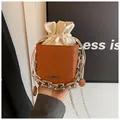 Brown leather square bag with embossed lettering, silver chain, and drawstring closure - Dark Brown