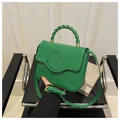 Bright green crocodile pattern handbag with a unique twisted woven handle and gold clasp - Green