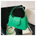 Detail view of bright green PU leather crossbody bag featuring gold Fashion lettering - Green