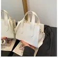 Elegant white leather small tote bag with golden hardware and adjustable strap - White