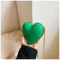 Mini heart-shaped crossbody bag in fruit green with golden chain strap and metal frame - Green