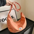 Minimalist apricot nylon half-moon crossbody bag with adjustable fabric shoulder strap - Orange