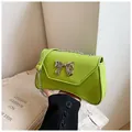 Neon green faux leather crossbody bag with silver bow accent and chain strap - Green
