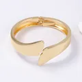 Minimalist asymmetric gold plated spring hinge cuff bracelet with polished finish - Small Wing Spring Bracelet / Gold