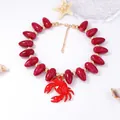 Detailed view of ocean style necklace with red resin beads and large crab pendant - Dark Red