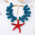 Detail of colorful resin beads and large red starfish pendant on beach style necklace - Dark Blue