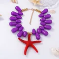 Colorful sea star pendant necklace with purple beads in a bohemian coastal style - Purple