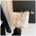 Creamy white ballet style bucket bag with crisscross lace-up ribbon detail and slim strap - White